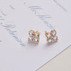 Greenwich 4 Birthstone earrings in 14k yellow gold featuring four 4 mm white topaz and one 2.1 mm diamond.