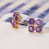 Pair of 14k yellow gold Greenwich 4 Birthstone earrings each featuring four 4 mm amethysts and one 2.1 mm diamond - close up