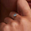 Woman wearing a personalized Grand Birthstone Ring with a 6mm round briolette-cut Aquamarine gemstone set in a lustrous 14k gold bezel.