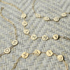 Flat lay of letter bracelets on Adelaide Mini chains featuring GRAMMY, NANA, MAMA, and MOM Heart bracelets.