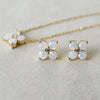 Greenwich Birthstone Earrings in 14k Gold featuring four 4 mm faceted round cut, prong set Opals and one 2.1 mm  Diamond. 