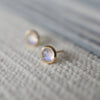 A 14k yellow gold Grand stud earring featuring one 6 mm briolette cut bezel set moonstone