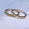 Two Rosecliff Peridot Stackable rings featuring eleven 2mm faceted round cut gemstones, one with alternating diamonds.