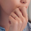 Woman adorned with a Rainbow Rosecliff stackable ring with 2mm rubies, citrines, emeralds, sapphires, amethysts, pink sapphires, and diamonds