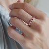 Woman's hand showcasing a Rosecliff Diamond & Ruby Stackable Ring in 14k gold.