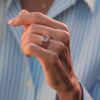 Woman adorned with a 14k yellow gold Warren Horizontal Rose Quartz Ring, showcasing an emerald-cut 8 x 10mm Rose Quartz, hand-set horizontally in a 14k-gold bezel.