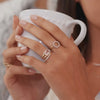 Woman showcasing a 14k yellow gold Warren Horizontal Rose Quartz Ring, featuring an emerald-cut 8 x 10mm Rose Quartz, hand-set horizontally in a 14k-gold bezel.