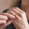 Woman wearing two Rosecliff Diamond & Garnet and Rosecliff Garnet Stackable Rings in 14k gold.