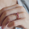 Hand adorned with Rosecliff Ruby Stackable Ring featuring eleven 2mm faceted round-cut Rubies prong set in 14k gold.