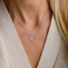 Woman wearing a Rosecliff Heart Diamond necklace featuring twenty 2mm gemstones on a 1.17mm cable chain in 14k yellow gold.