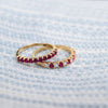 Pair of Rosecliff stackable rings featuring round cut rubies, one with alternating diamonds, prong set in 14k yellow gold