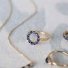 Assorted Sapphire jewerly, including a Rosecliff small open circle ring featuring twelve 2 mm round cut sapphires prong set in 14k gold