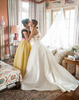 A smiling bride hugging her mother in the bridal suite.