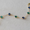 Terra 7 Stone bracelet featuring seven alternating 4mm bezel set sapphire and emerald gemstones on a 1.17mm cable chain.