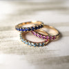 Trio of Rosecliff Stackable Rings in 14k gold, featuring Sapphire, Pink Sapphire, and Blue Topaz gemstones.