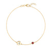 14k yellow gold Classic bracelet featuring one garnet and one 1/4” flat disc engraved with the letter A - front view