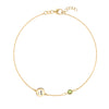 14k yellow gold Classic bracelet featuring one peridot and one 1/4” flat disc engraved with the letter A - front view