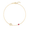 14k yellow gold Classic bracelet featuring one ruby and one 1/4” flat disc engraved with the letter A - front view