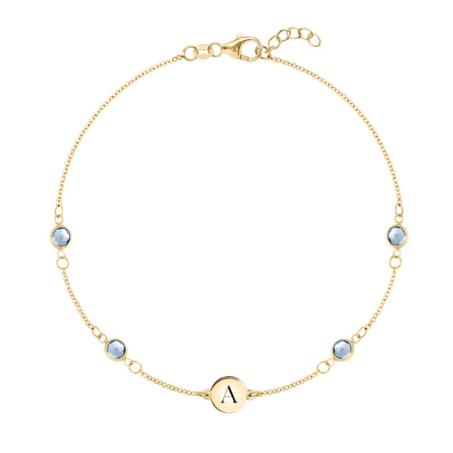 14k yellow gold Classic bracelet featuring four aquamarines and one 1/4” flat disc engraved with the letter A - front view