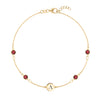 14k yellow gold Classic bracelet featuring four garnets and one 1/4” flat disc engraved with the letter A - front view