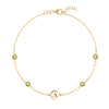 14k yellow gold Classic bracelet featuring four peridots and one 1/4” flat disc engraved with the letter A - front view