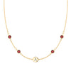 14k gold cable chain Classic necklace featuring four garnets and one 1/4” flat disc engraved with the letter A - front view