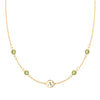 14k gold cable chain Classic necklace featuring four peridots and one 1/4” flat disc engraved with the letter A - front view