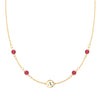 14k gold cable chain Classic necklace featuring four rubies and one 1/4” flat disc engraved with the letter A - front view
