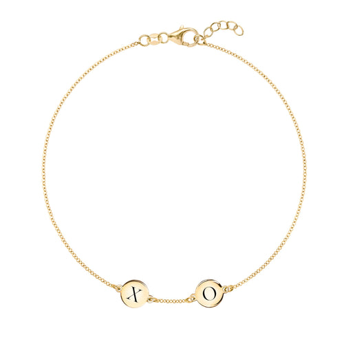 14k yellow gold cable chain bracelet featuring two 1/4” flat engraved letter discs, spelling XO - front view