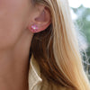 Woman wearing a 14k yellow gold Greenwich 5 Birthstone earring featuring five 4 mm pink tourmalines and one 2.1 mm diamond