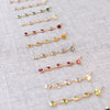 Nine Newport earrings each featuring five 4 mm briolette cut gemstones in various colors bezel set in 14k yellow gold