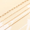 Various necklaces including the Saffron 14k yellow gold rolo chain necklace