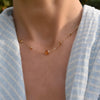 Woman with a Grand & Classic necklace featuring one 6 mm and four 4 mm Citrines bezel set in 14k yellow gold