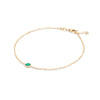 Classic cable chain bracelet featuring one 4 mm briolette cut emerald bezel set in 14k yellow gold - angled view