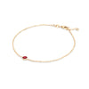 Classic cable chain bracelet featuring one 4 mm briolette cut garnet bezel set in 14k yellow gold - angled view