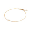 Classic cable chain bracelet featuring one 4 mm briolette cut moonstone bezel set in 14k yellow gold - angled view