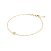 Classic cable chain bracelet featuring one 4 mm briolette cut peridot bezel set in 14k yellow gold - angled view