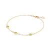 Bayberry 1.17 mm cable chain birthstone bracelet featuring three 4 mm briolette peridots bezel set in 14k gold - angled view
