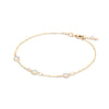 Personalized cable chain bracelet featuring three 4 mm briolette cut gemstones bezel set in 14k yellow gold - angled view