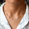 Woman wearing a Grand & Classic 14k gold 1.17 mm cable chain necklace featuring four 4 mm & four 6 mm briolette cut gemstones