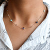 Woman wearing a Grand & Classic 14k gold 1.17 mm cable chain necklace featuring five 4 mm & five 6 mm briolette cut gemstones