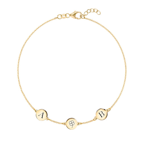 14k gold Classic bracelet featuring three 1/4” flat discs, one engraved with a four leaf clover, two with the letters A & B