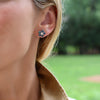 Woman wearing a 14k yellow gold Greenwich 5 Birthstone earring featuring five 4 mm alexandrites and one 2.1 mm diamond