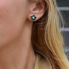 Woman wearing a 14k yellow gold Greenwich 5 Birthstone earring featuring five 4 mm emeralds and one 2.1 mm diamond