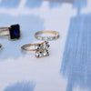 Several rings including a Greenwich ring featuring four 4 mm round white topaz and one 2.1 mm diamond prong set in 14k gold