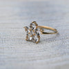 Greenwich ring featuring five 4 mm faceted round cut white topaz and one 2.1 mm diamond prong set in 14k yellow gold