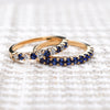 A pair of Rosecliff stackable rings in 14k gold featuring 2mm round cut prong set sapphires, one with alternating diamonds