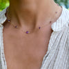 Woman wearing a Bayberry Grand & Classic 14k gold necklace featuring alternating 4 mm and 6 mm briolette cut amethysts
