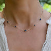 Woman wearing a Bayberry Grand & Classic 14k gold necklace featuring alternating 4 mm and 6 mm briolette cut sapphires