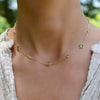 Woman with a Bayberry Grand & Classic 14k gold necklace featuring alternating 4 mm & 6 mm briolette cut bezel set peridots